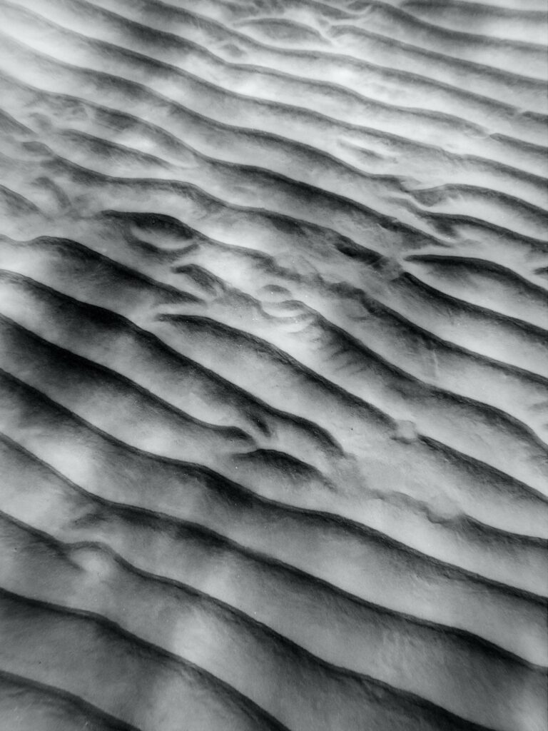 grey sand with waves